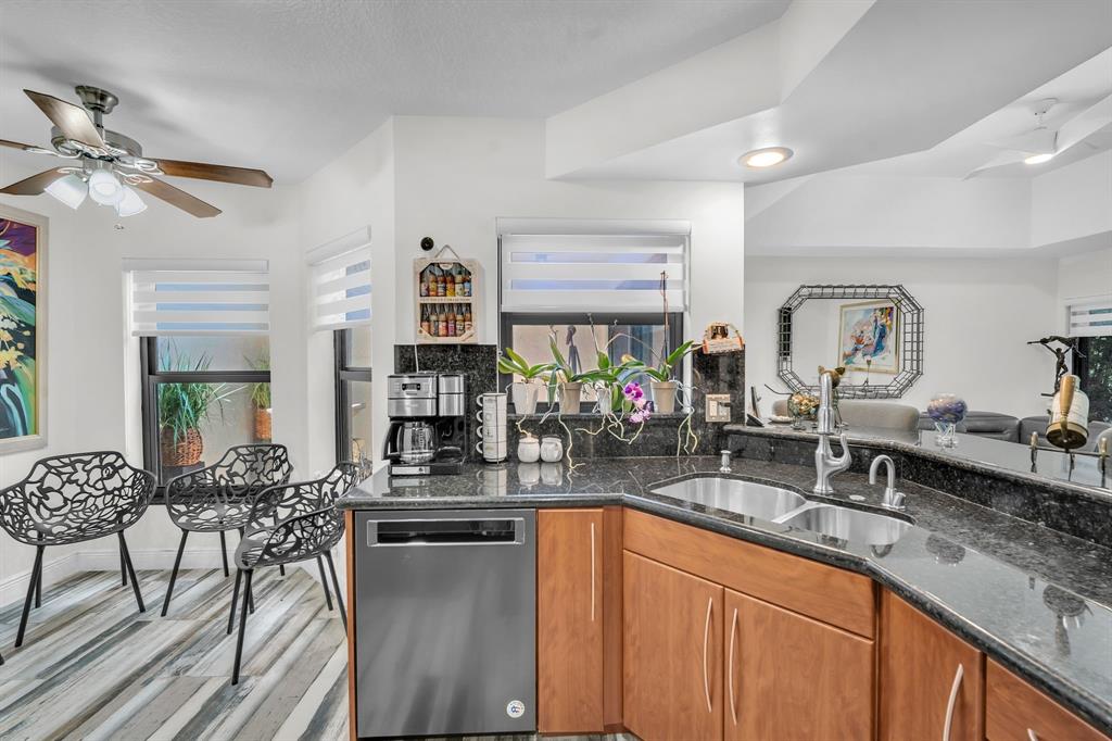 820 Southwest 87th Terrace Plantation, FL 33324 - Photo 27 of 41 a kitchen with stainless steel appliances granite countertop sink stove and cabinets