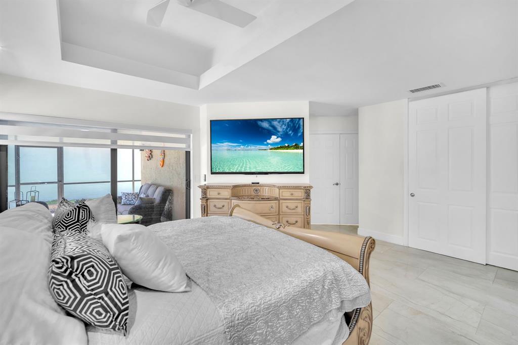 820 Southwest 87th Terrace Plantation, FL 33324 - Photo 30 of 41 a bedroom with a large bed and a flat screen tv