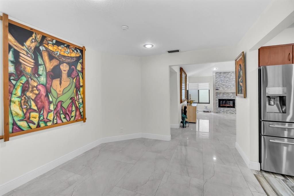 820 Southwest 87th Terrace Plantation, FL 33324 - Photo 3 of 41 a view of hallway with cabinets and refrigerator