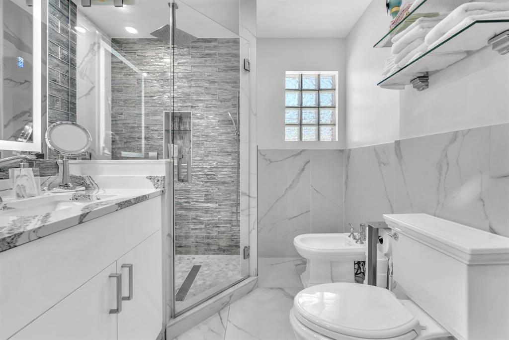 820 Southwest 87th Terrace Plantation, FL 33324 - Photo 31 of 41 a bathroom with a granite countertop toilet sink and a shower