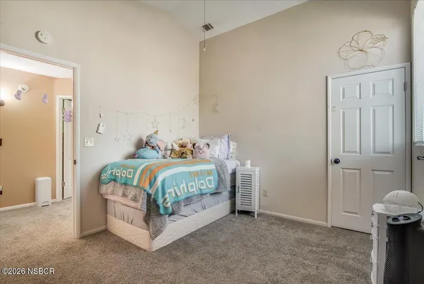 a bedroom with a bed and a table