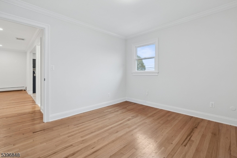 3 Witherspoon Street, Unit 2 Nutley, NJ 07110 - Photo 13 of 19 a view of an empty room with wooden floor and a window