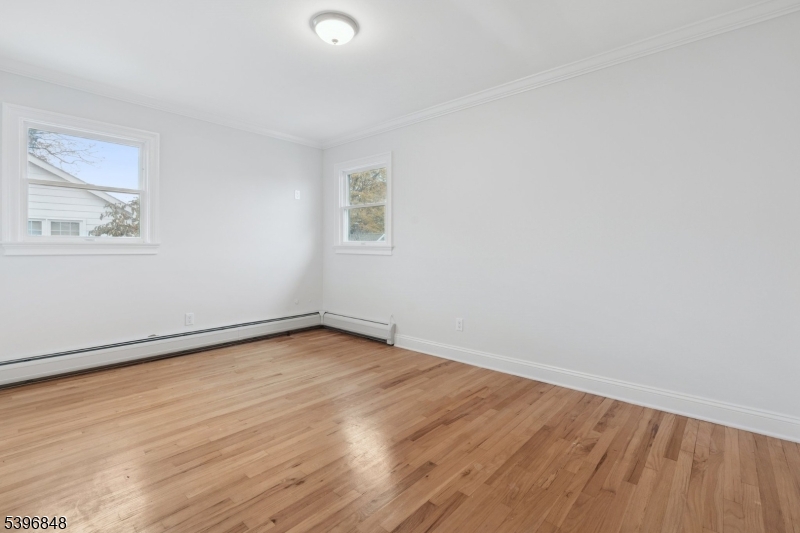 3 Witherspoon Street, Unit 2 Nutley, NJ 07110 - Photo 14 of 19 an empty room with wooden floor and windows