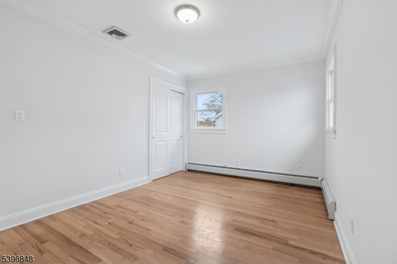 3 Witherspoon Street, Unit 2 Nutley, NJ 07110 - Photo 15 of 19 an empty room with wooden floor and windows
