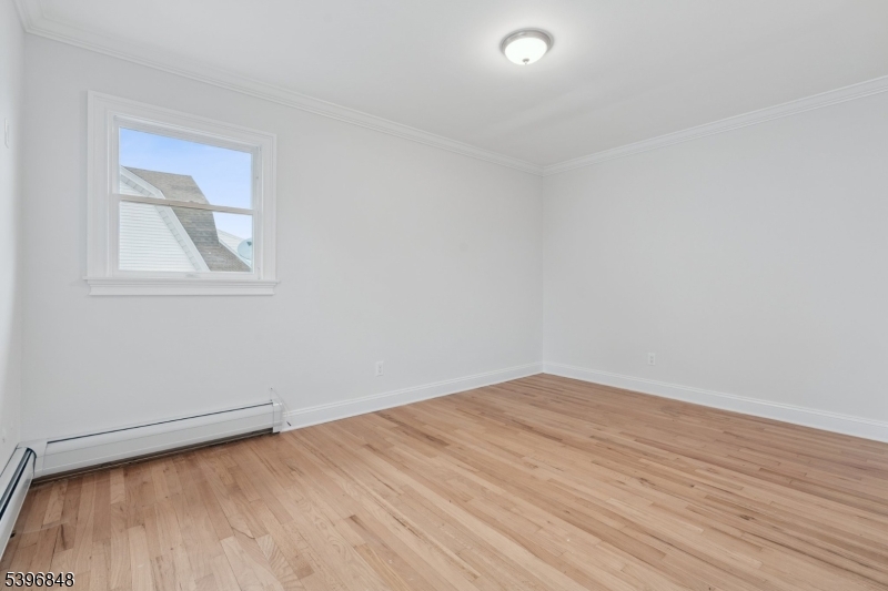 3 Witherspoon Street, Unit 2 Nutley, NJ 07110 - Photo 16 of 19 an empty room with wooden floor and windows