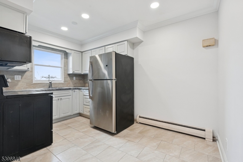 3 Witherspoon Street, Unit 2 Nutley, NJ 07110 - Photo 6 of 19 a kitchen with a refrigerator and a sink