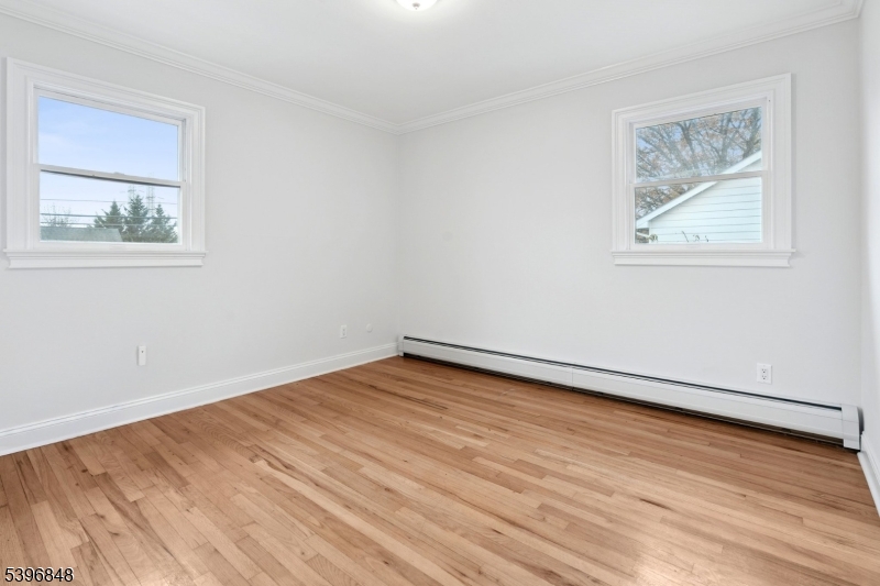 3 Witherspoon Street, Unit 2 Nutley, NJ 07110 - Photo 10 of 19 a view of an empty room with wooden floor and a window