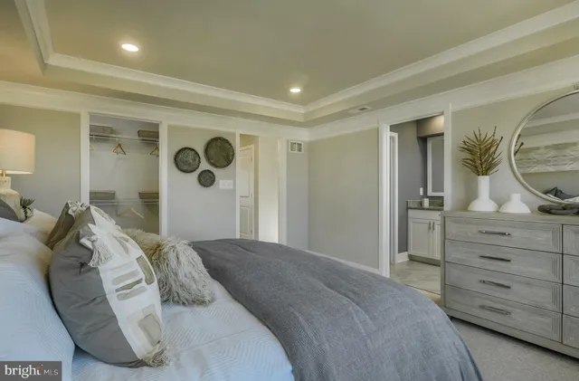 a bedroom with a bed and a dresser