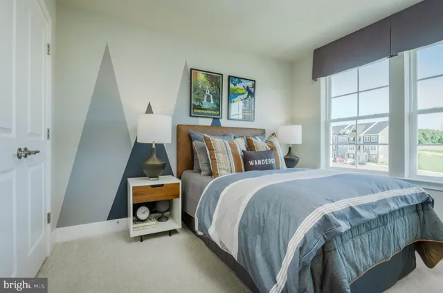 a bed sitting in a bedroom next to a window