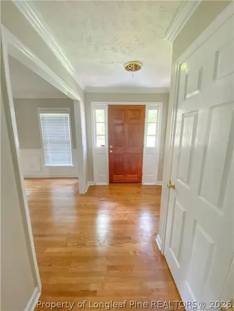 a view of an empty room with a window and fireplace