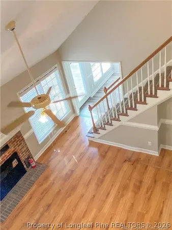 an empty room with wooden floor and window