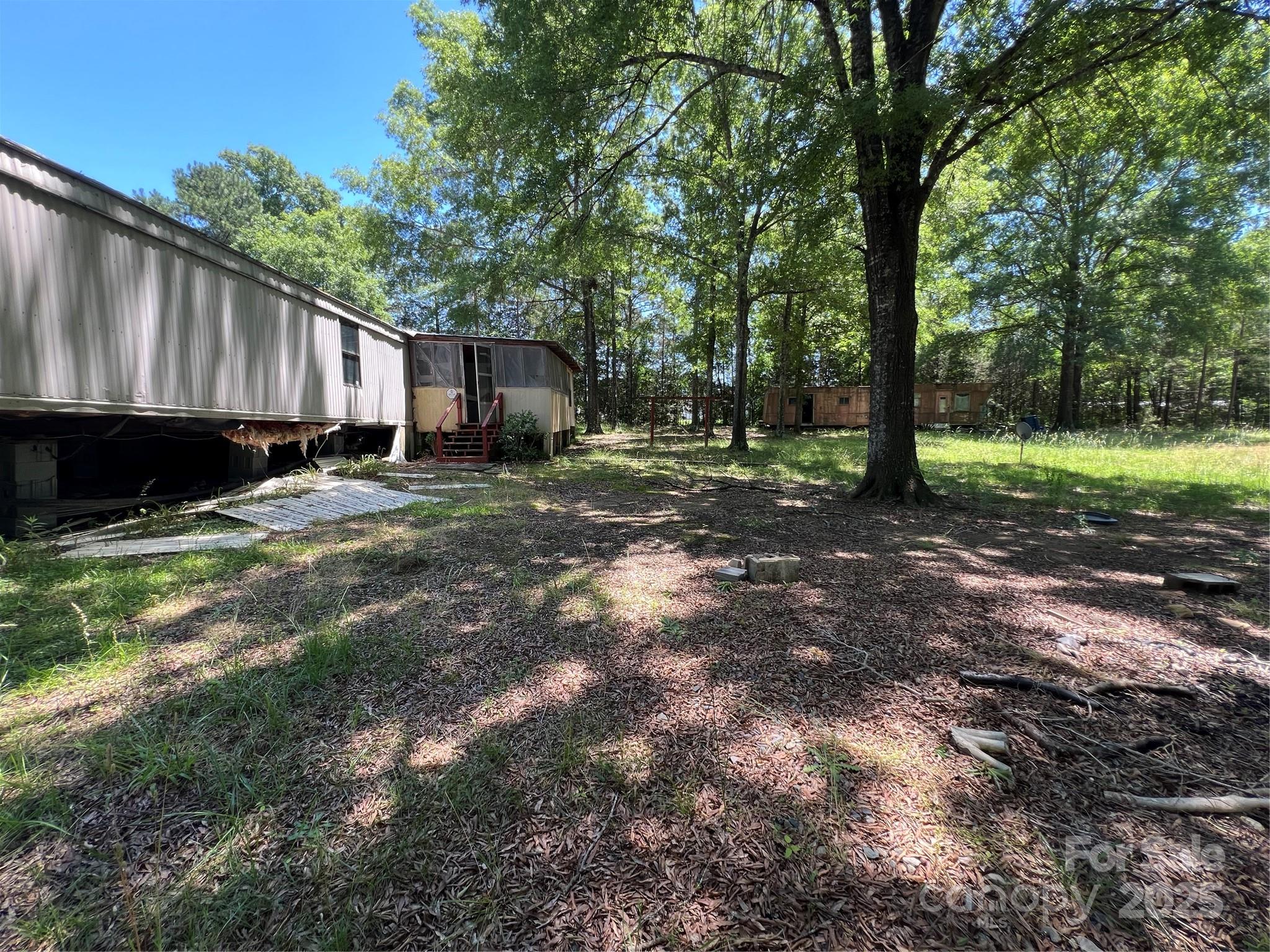 5655 Shirley Road Fort Lawn, SC 29714 - Photo 17 of 23 a view of a backyard with large trees and wooden fence