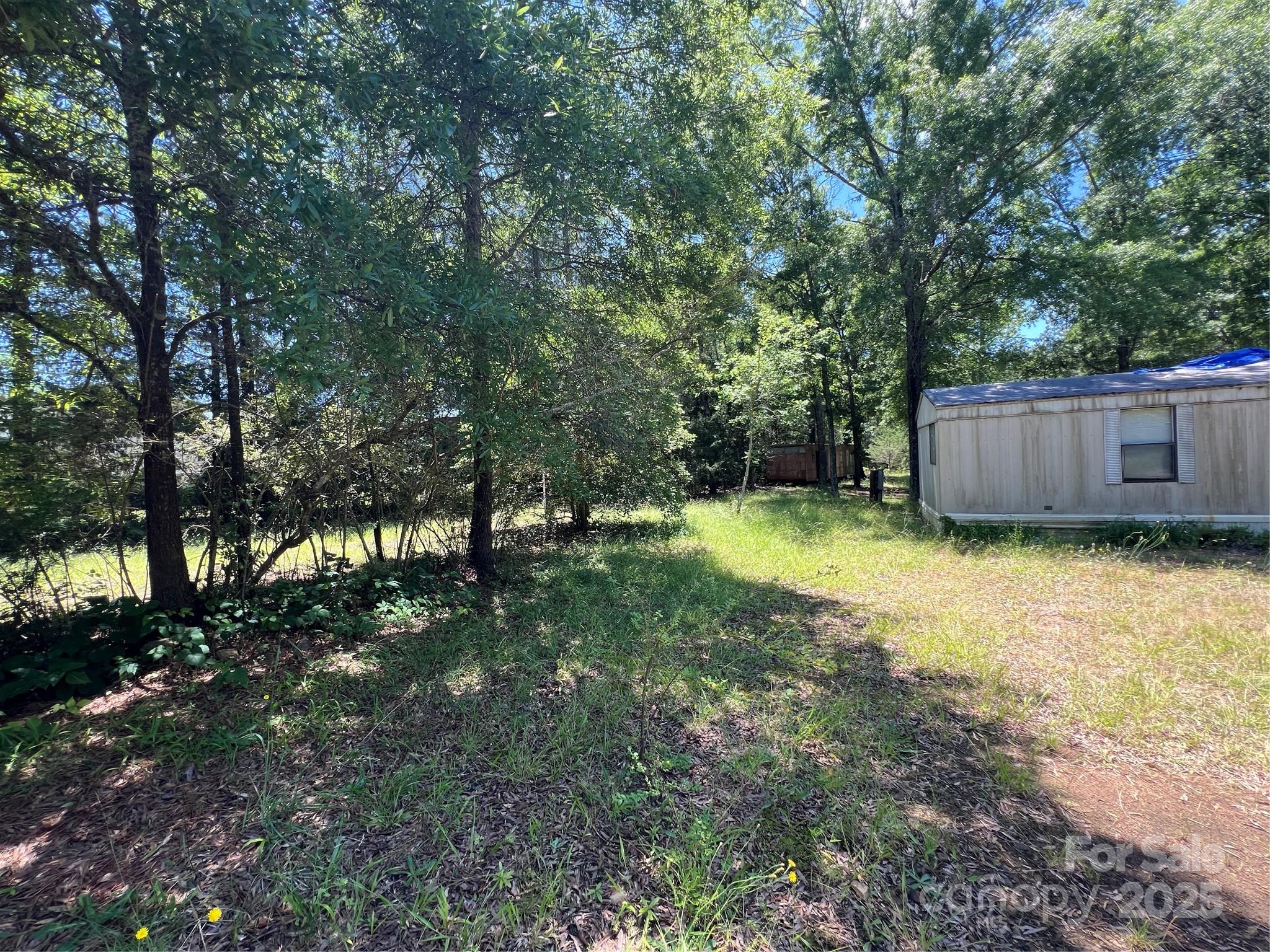5655 Shirley Road Fort Lawn, SC 29714 - Photo 5 of 23 a view of a backyard with large trees and wooden fence