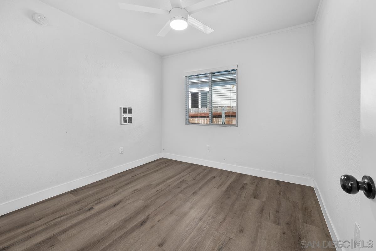 2948 Franklin Avenue San Diego, CA 92113 - Photo 13 of 47 an empty room with wooden floor and windows