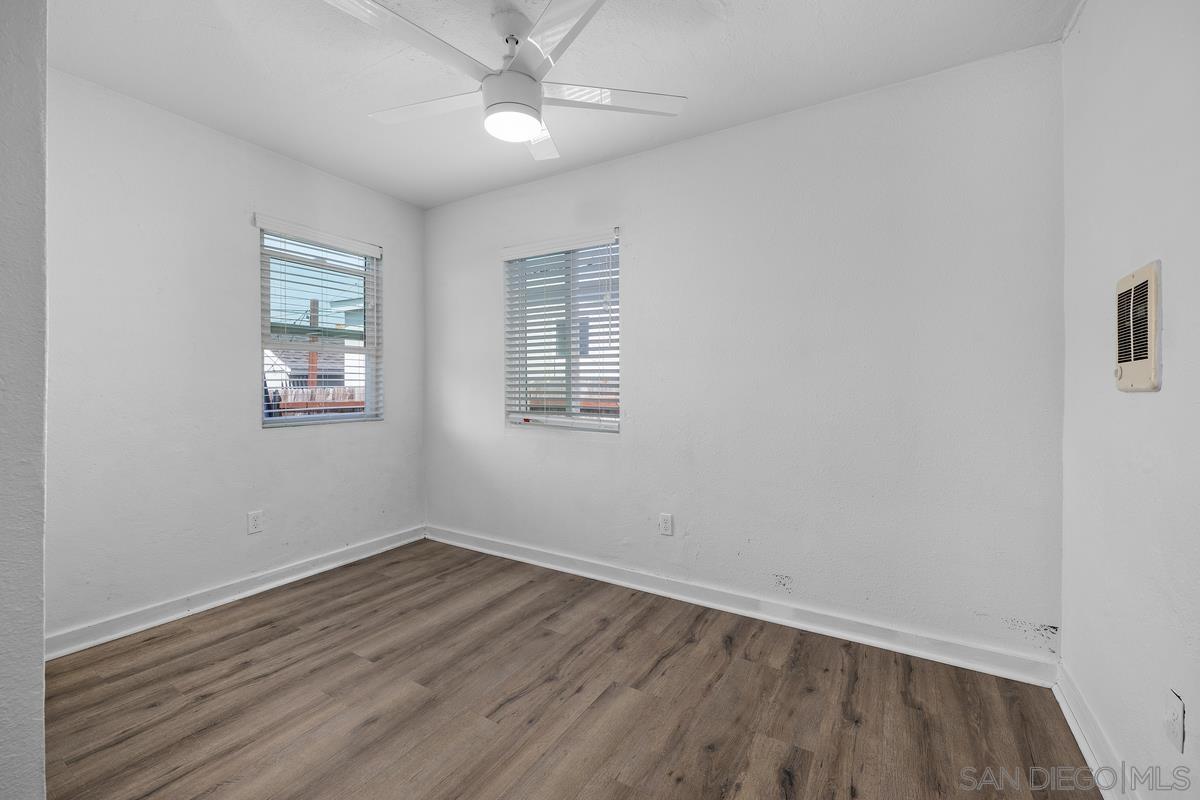 2948 Franklin Avenue San Diego, CA 92113 - Photo 14 of 47 an empty room with wooden floor fan and windows