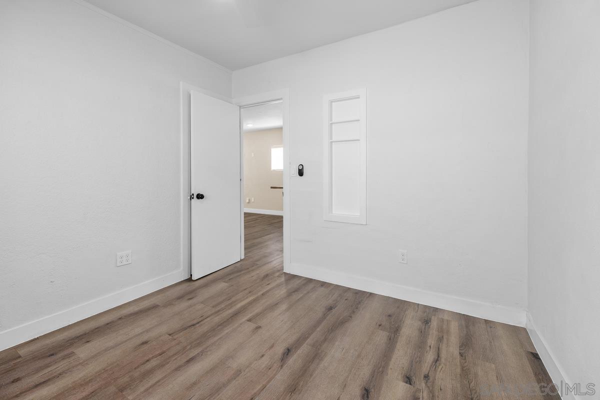 2948 Franklin Avenue San Diego, CA 92113 - Photo 17 of 47 a view of an empty room with wooden floor