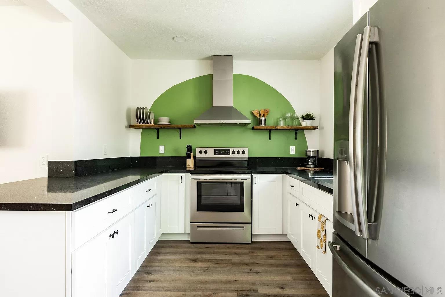 2948 Franklin Avenue San Diego, CA 92113 - Photo 26 of 47 a kitchen with stainless steel appliances granite countertop a sink and a stove