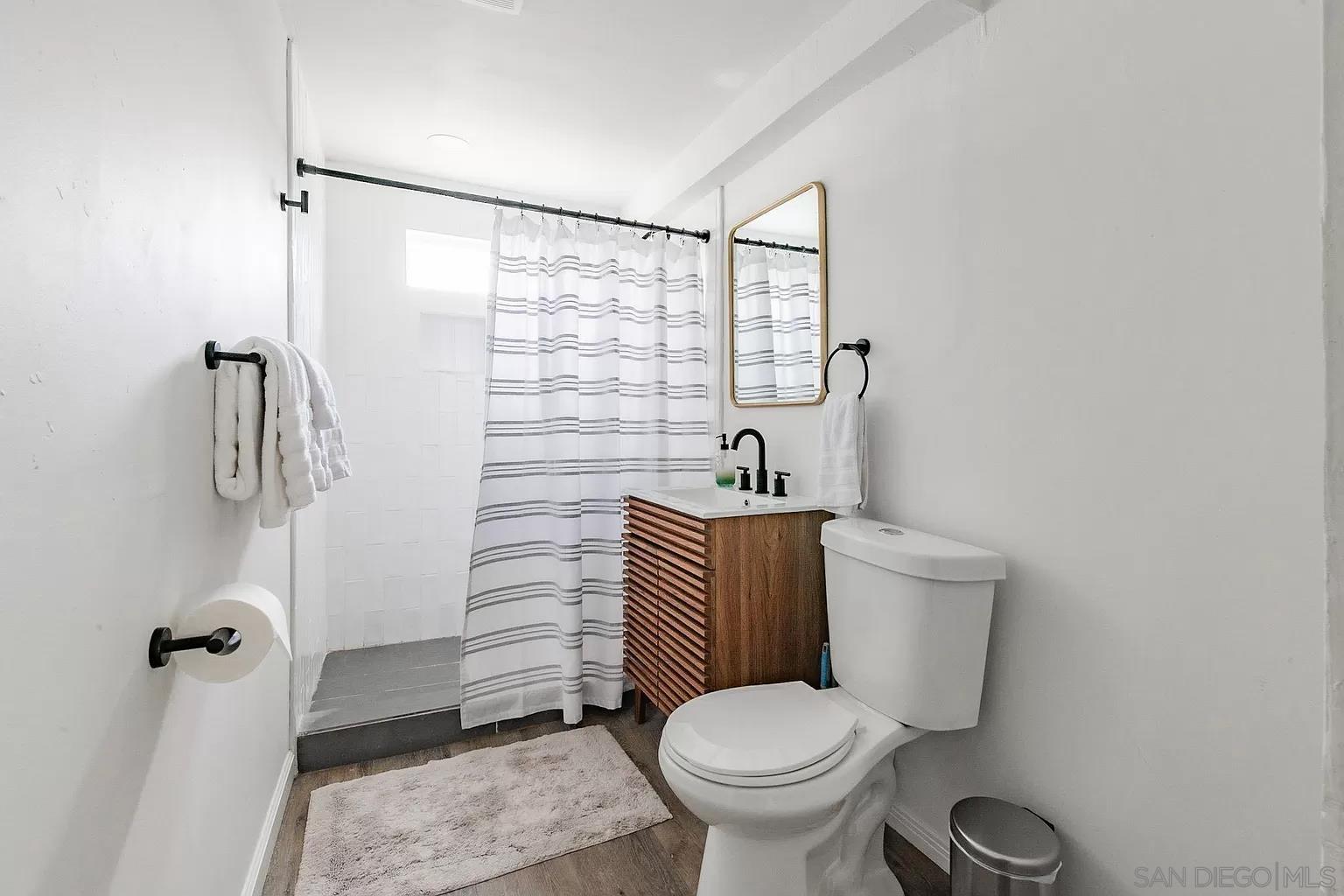 2948 Franklin Avenue San Diego, CA 92113 - Photo 35 of 47 a bathroom with a toilet and a shower