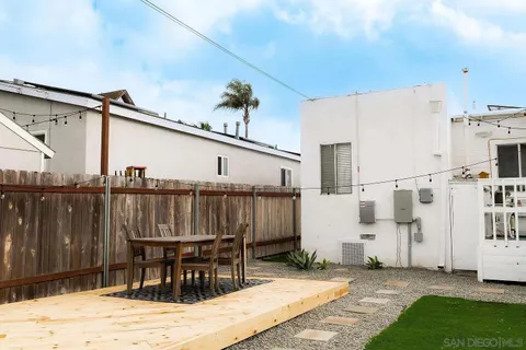 a view of a house with swimming pool and sitting area