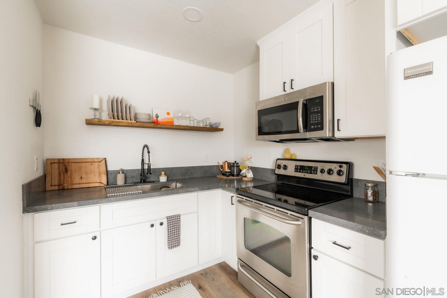 2948 Franklin Avenue San Diego, CA 92113 - Photo 41 of 47 a kitchen with granite countertop a sink and a stove