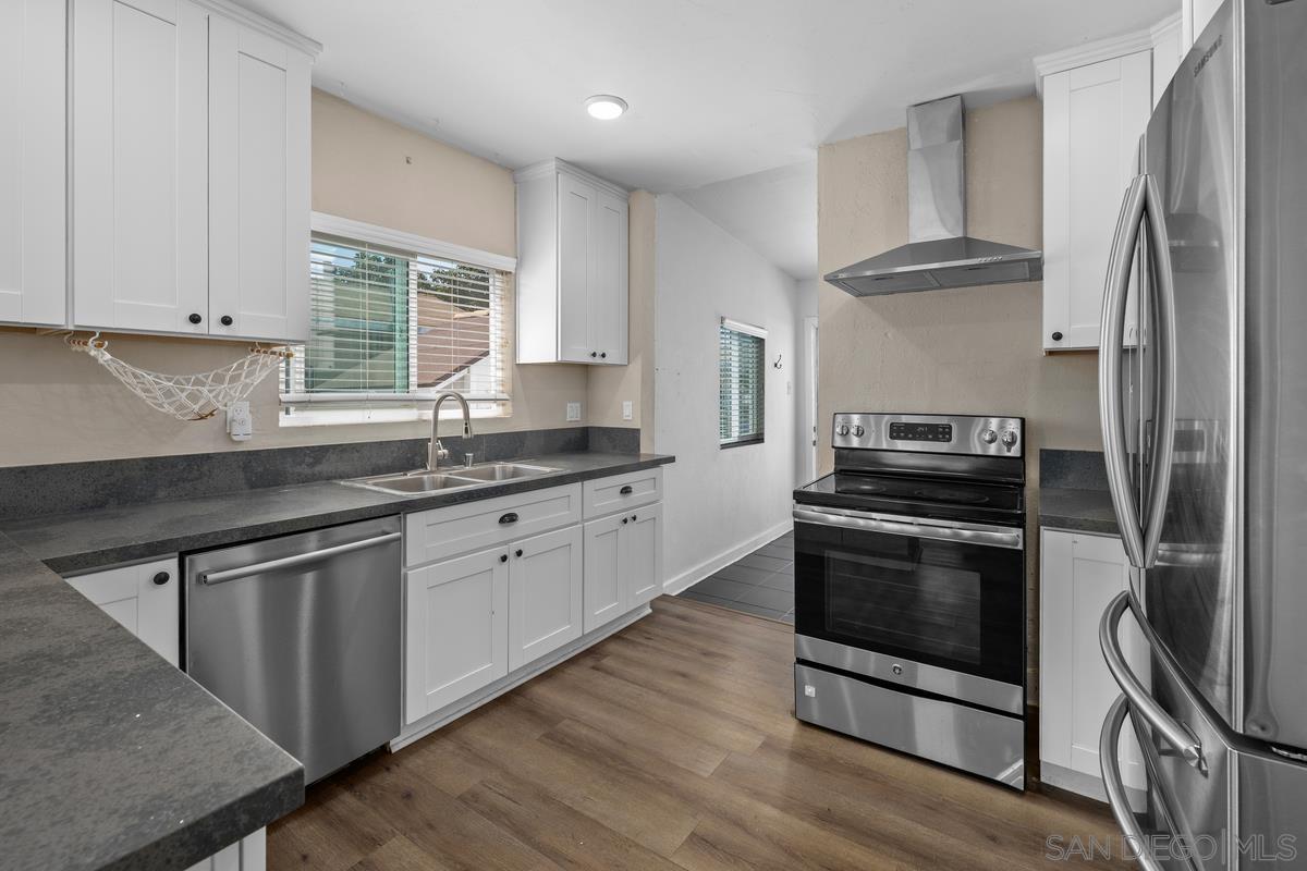 2948 Franklin Avenue San Diego, CA 92113 - Photo 9 of 47 a kitchen with stainless steel appliances granite countertop a sink stove and refrigerator