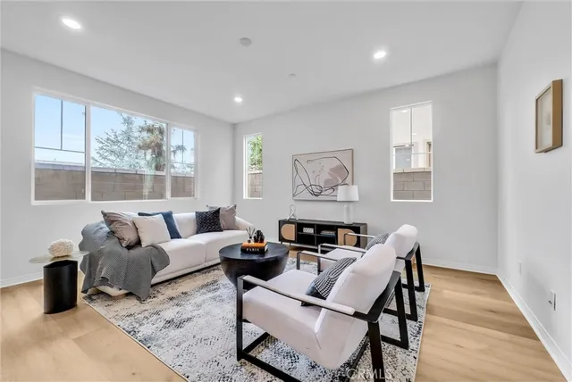 a living room with furniture and a potted plant