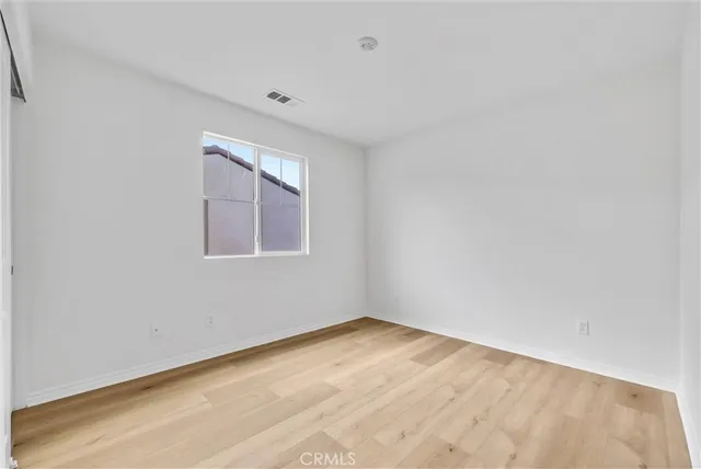 a bedroom with two beds and a large window