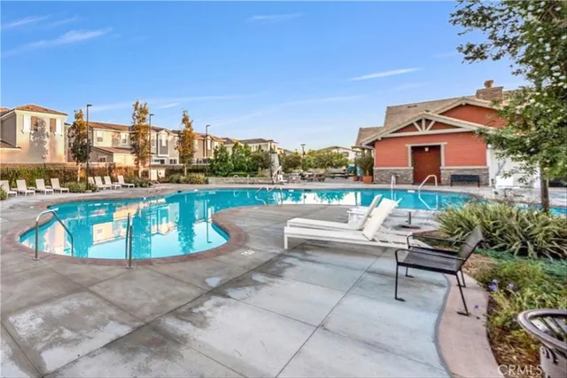 a view of a lake with a water fall and outdoor seating