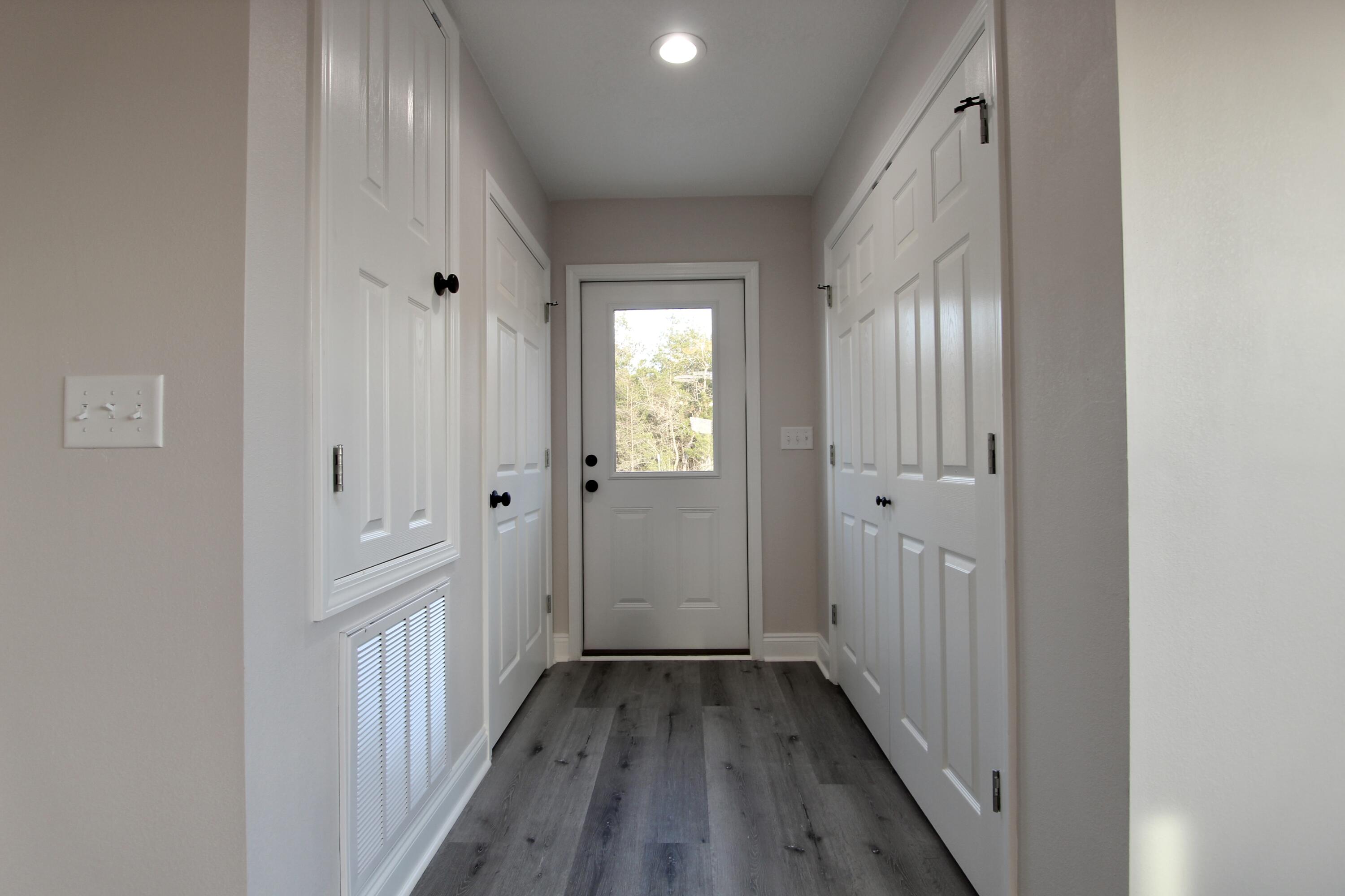 5437 Bayleaf Drive Crestview, FL 32539 - Photo 14 of 35 a view of a hallway with wooden floor