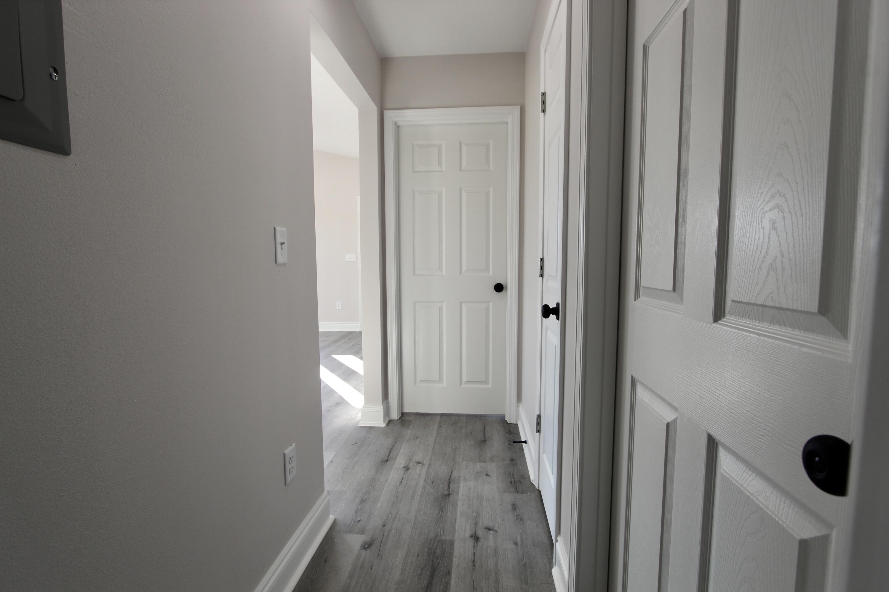 5437 Bayleaf Drive Crestview, FL 32539 - Photo 16 of 35 a view of a hallway with wooden floor