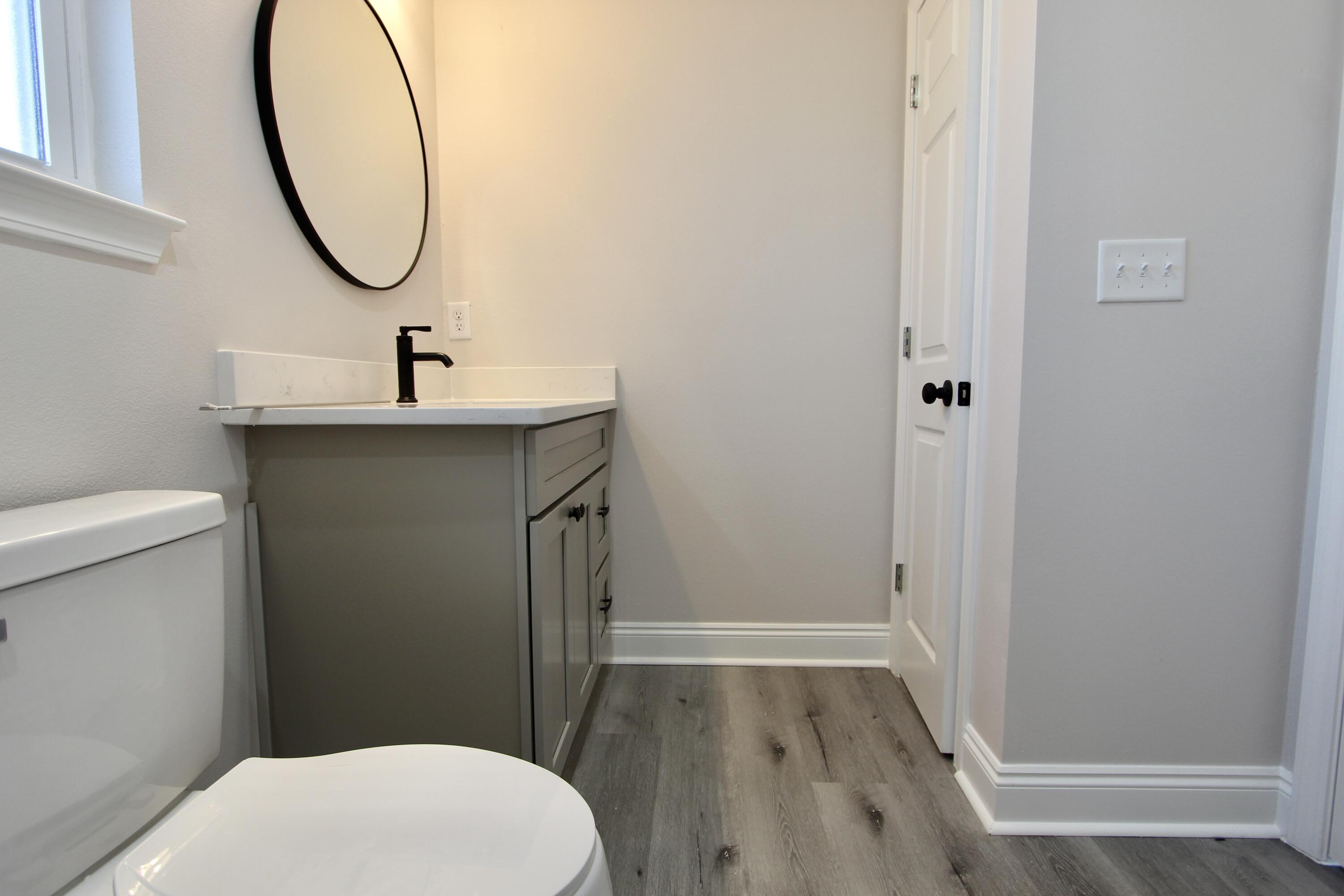 5437 Bayleaf Drive Crestview, FL 32539 - Photo 22 of 35 a bathroom with a sink a toilet and a mirror