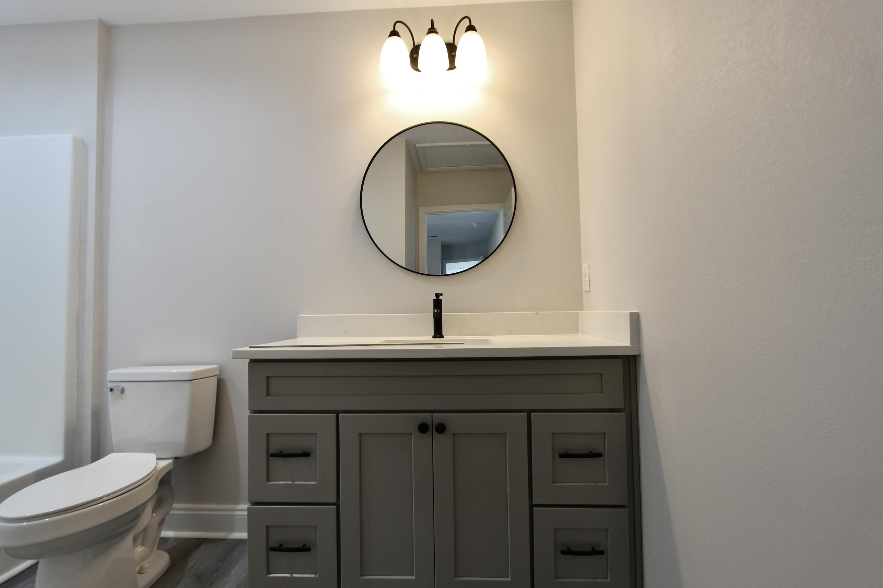 5437 Bayleaf Drive Crestview, FL 32539 - Photo 26 of 35 a bathroom with a toilet a sink and mirror