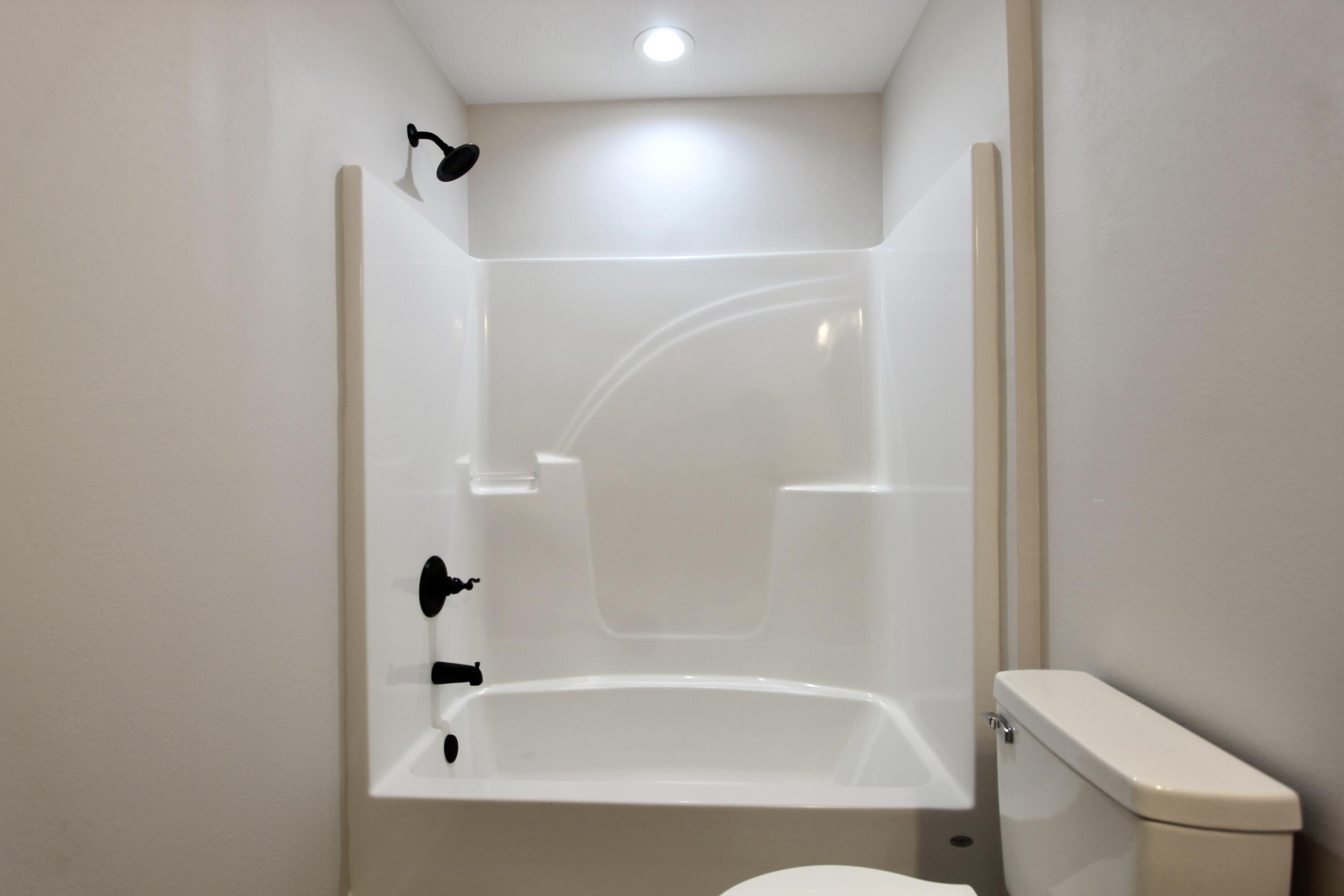 5437 Bayleaf Drive Crestview, FL 32539 - Photo 27 of 35 a bathroom with a bathtub and a shower