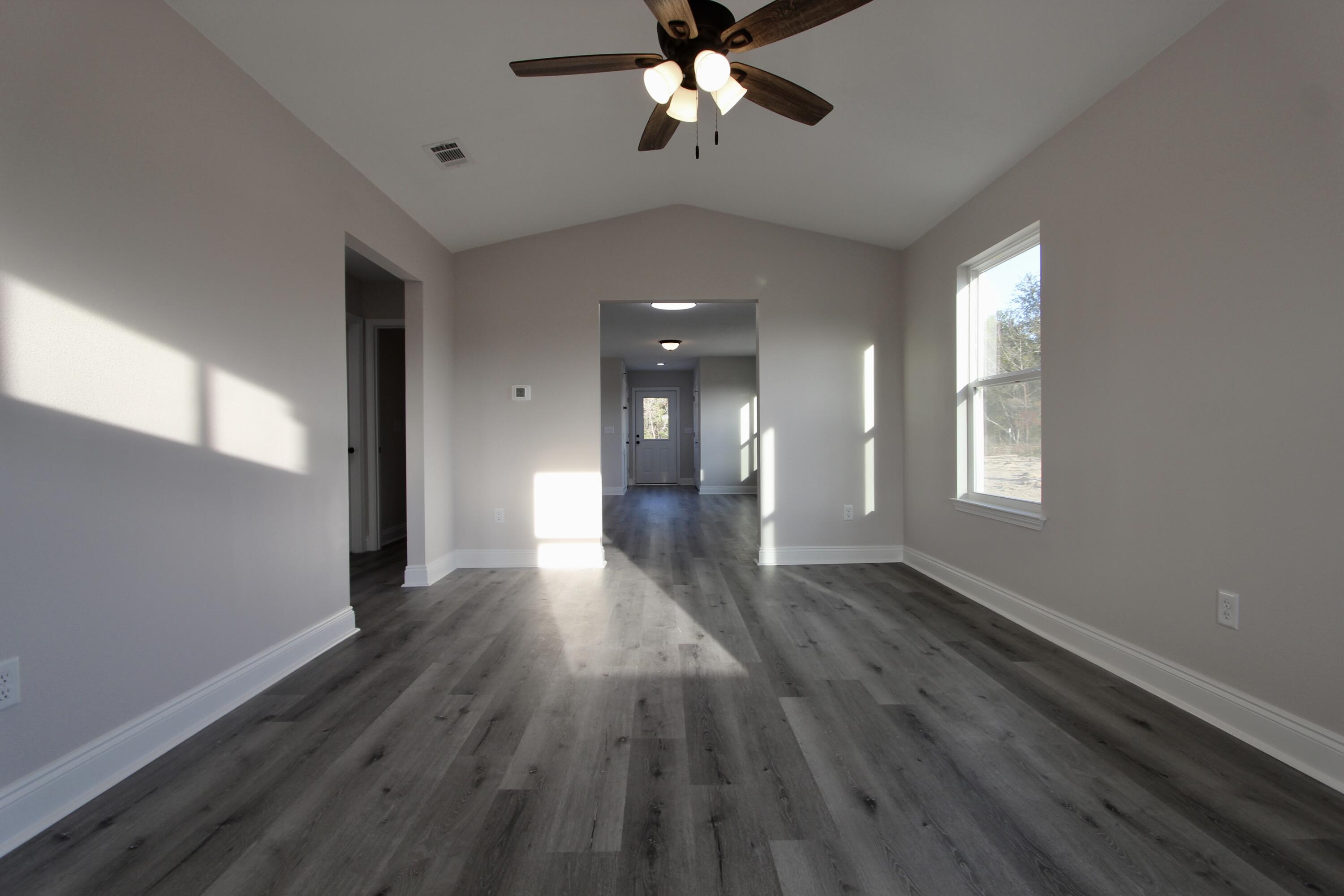 5437 Bayleaf Drive Crestview, FL 32539 - Photo 5 of 35 a view of empty room with wooden floor and fan