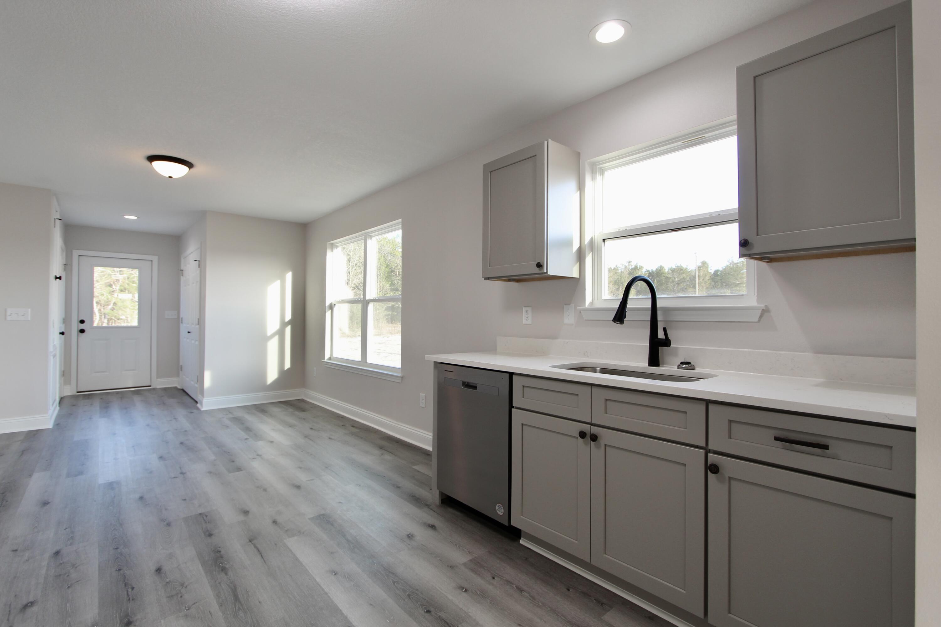 5437 Bayleaf Drive Crestview, FL 32539 - Photo 10 of 35 a kitchen with a sink cabinets and wooden floor