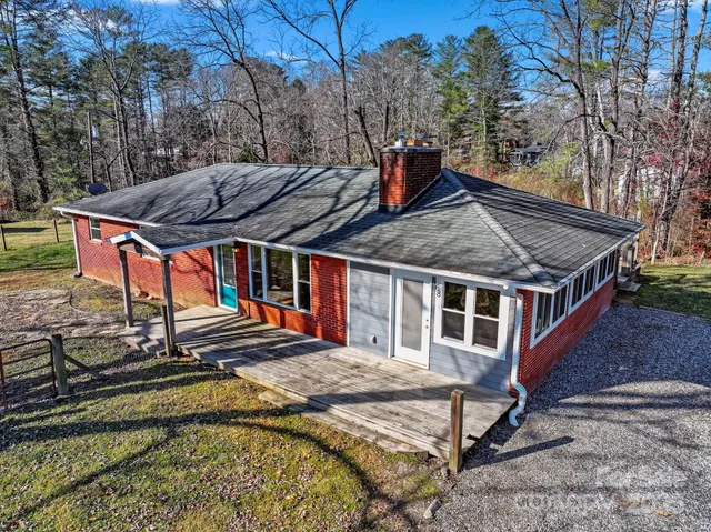 a view of a house with pool and sitting area