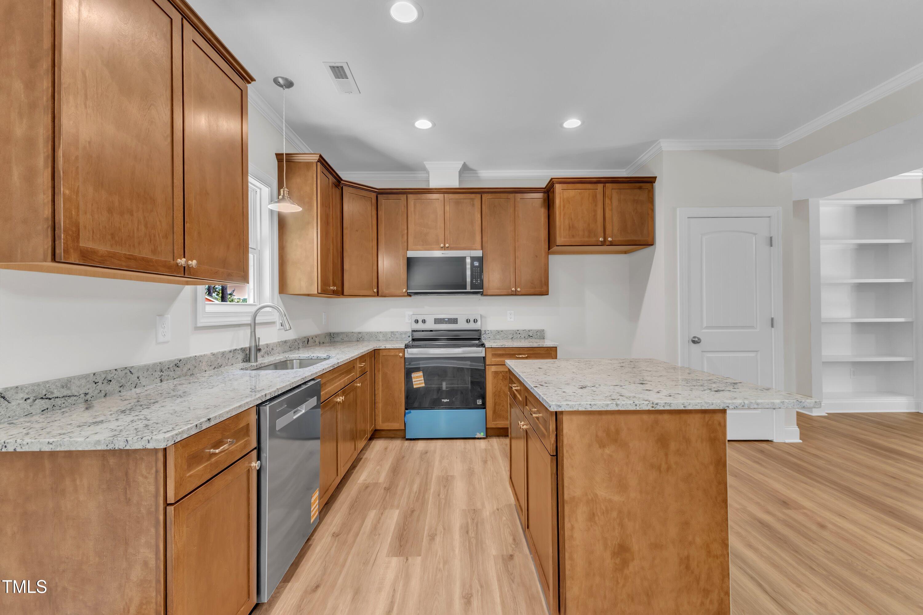 125 Davis Street Louisburg, NC 27549 - Photo 15 of 39 a kitchen with stainless steel appliances granite countertop a sink stove and refrigerator