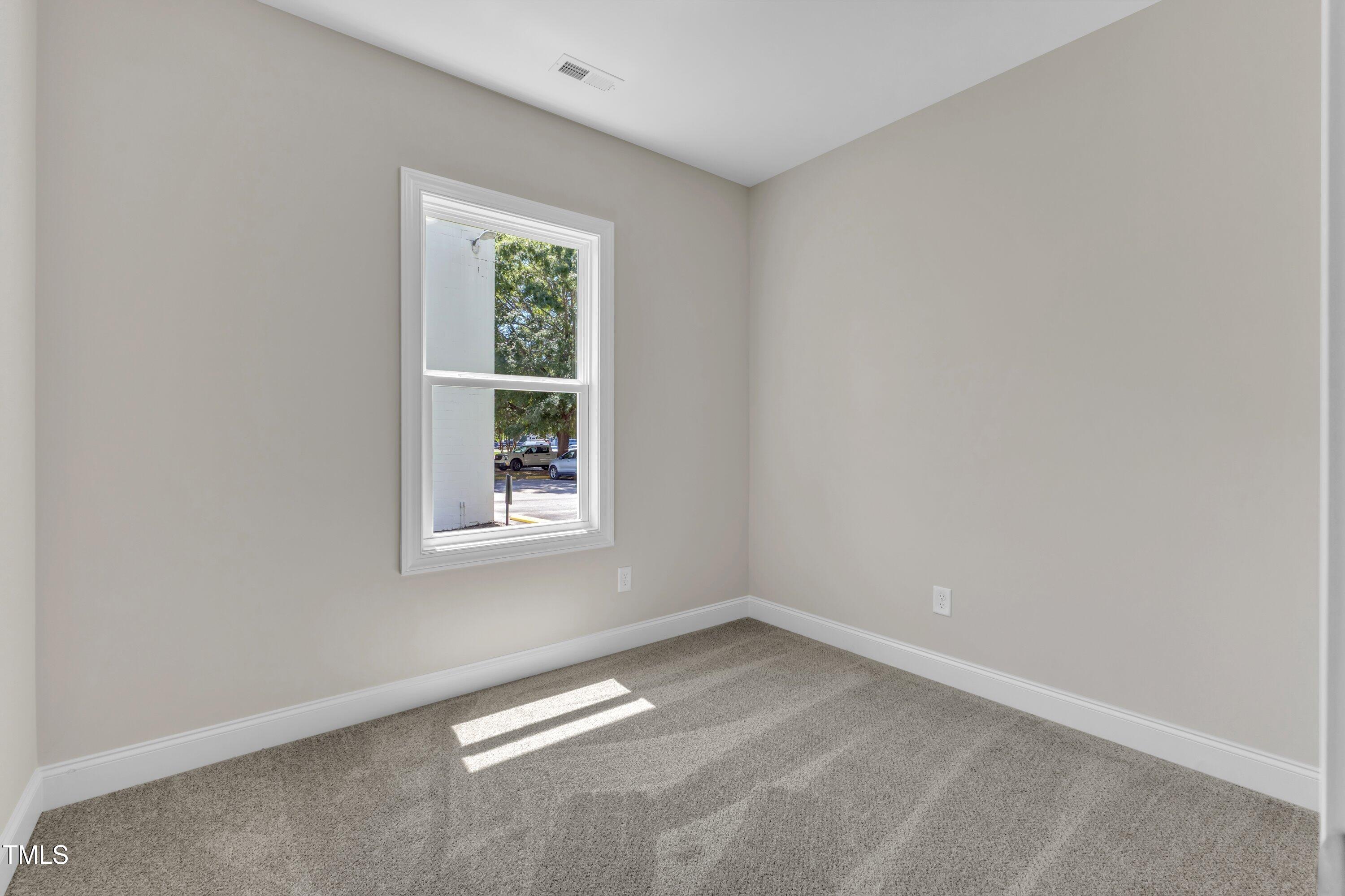 125 Davis Street Louisburg, NC 27549 - Photo 19 of 39 an empty room with a window