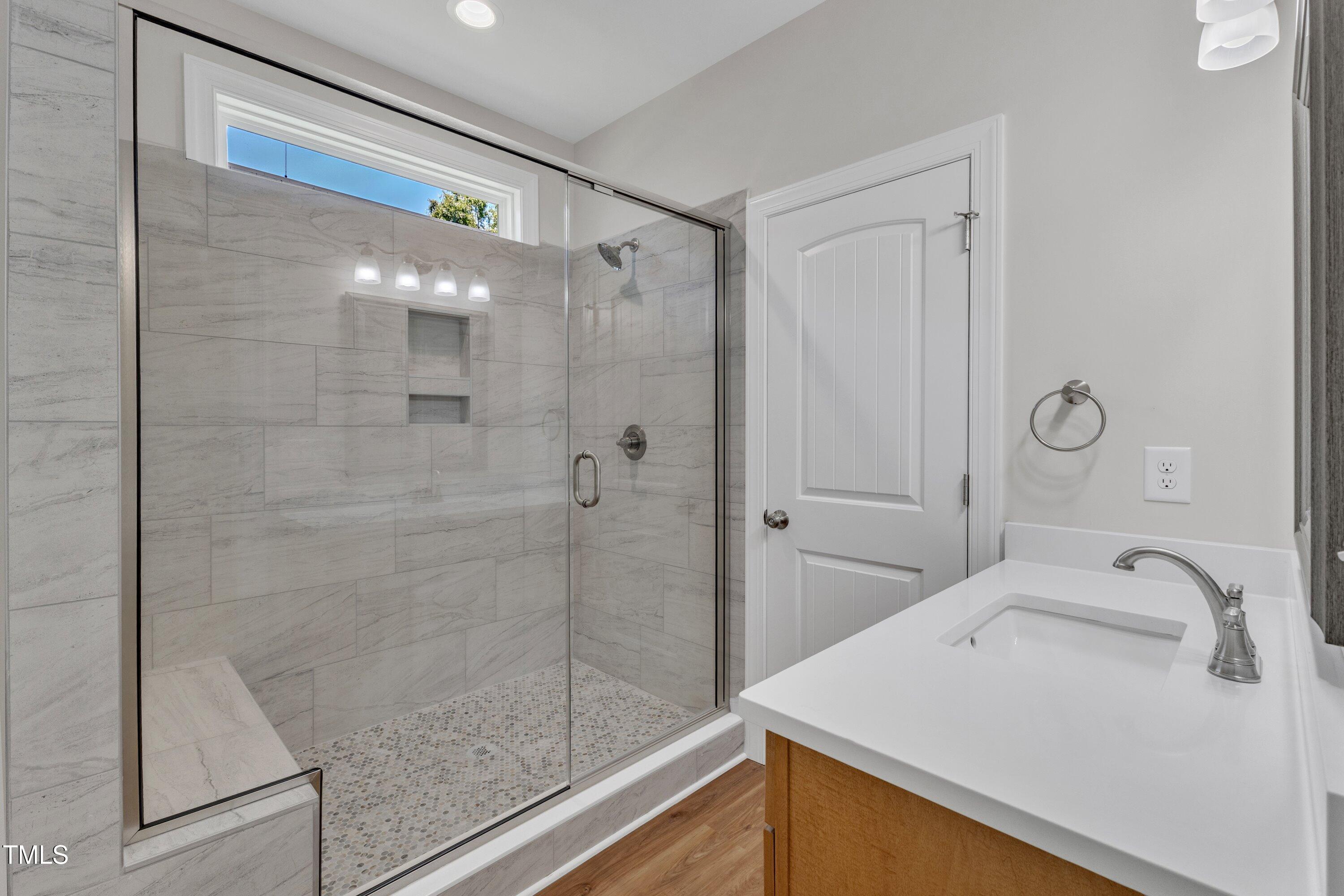 125 Davis Street Louisburg, NC 27549 - Photo 23 of 39 a bathroom with a sink and a mirror