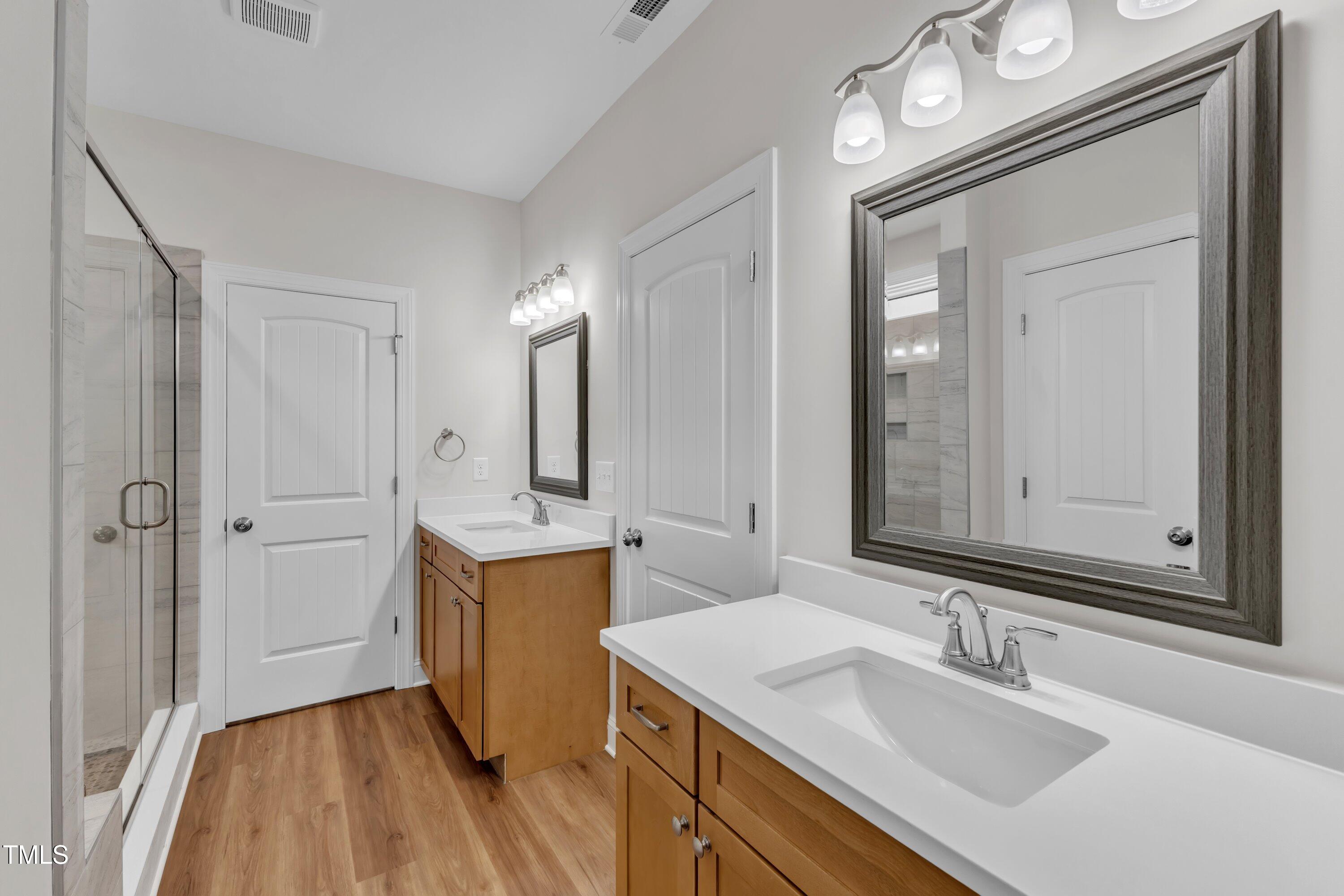 125 Davis Street Louisburg, NC 27549 - Photo 24 of 39 a bathroom with a sink vanity granite tub and shower