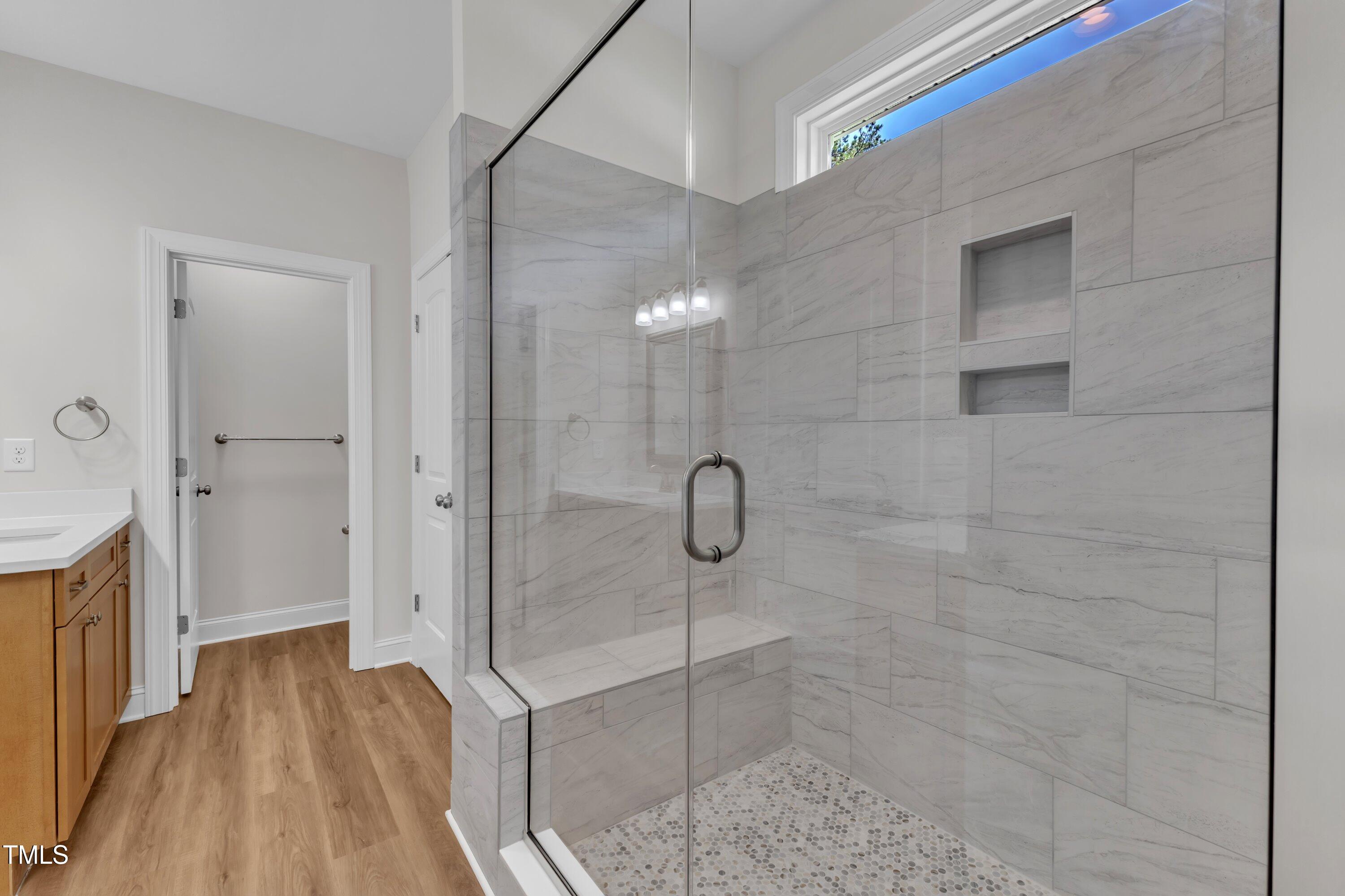 125 Davis Street Louisburg, NC 27549 - Photo 26 of 39 a bathroom with a glass shower door