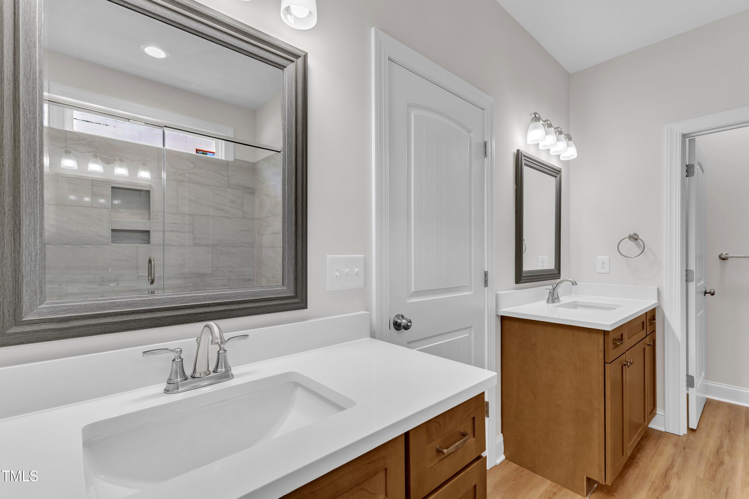 125 Davis Street Louisburg, NC 27549 - Photo 27 of 39 a bathroom with a sink double vanity granite and a mirror