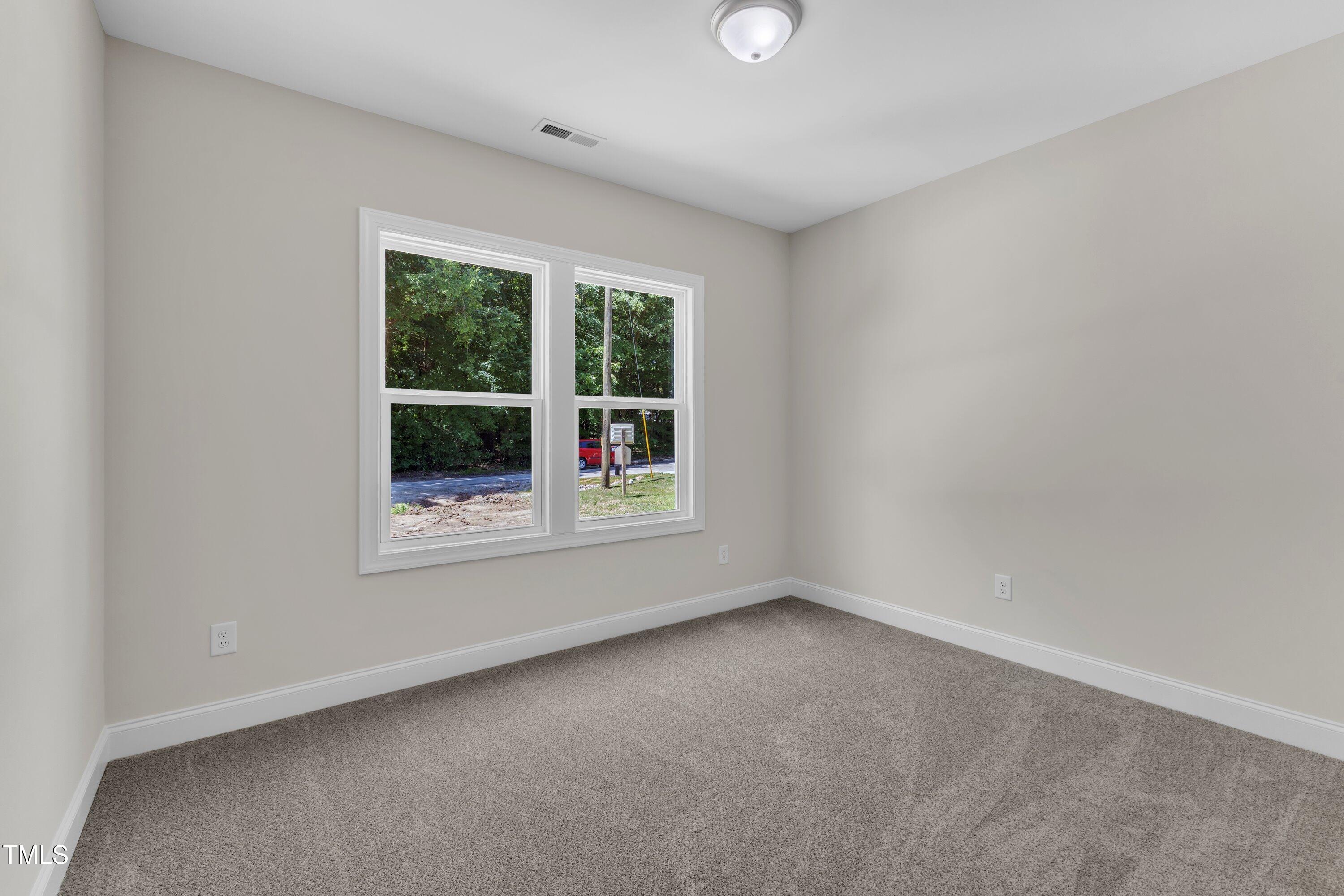 125 Davis Street Louisburg, NC 27549 - Photo 30 of 39 an empty room with a window