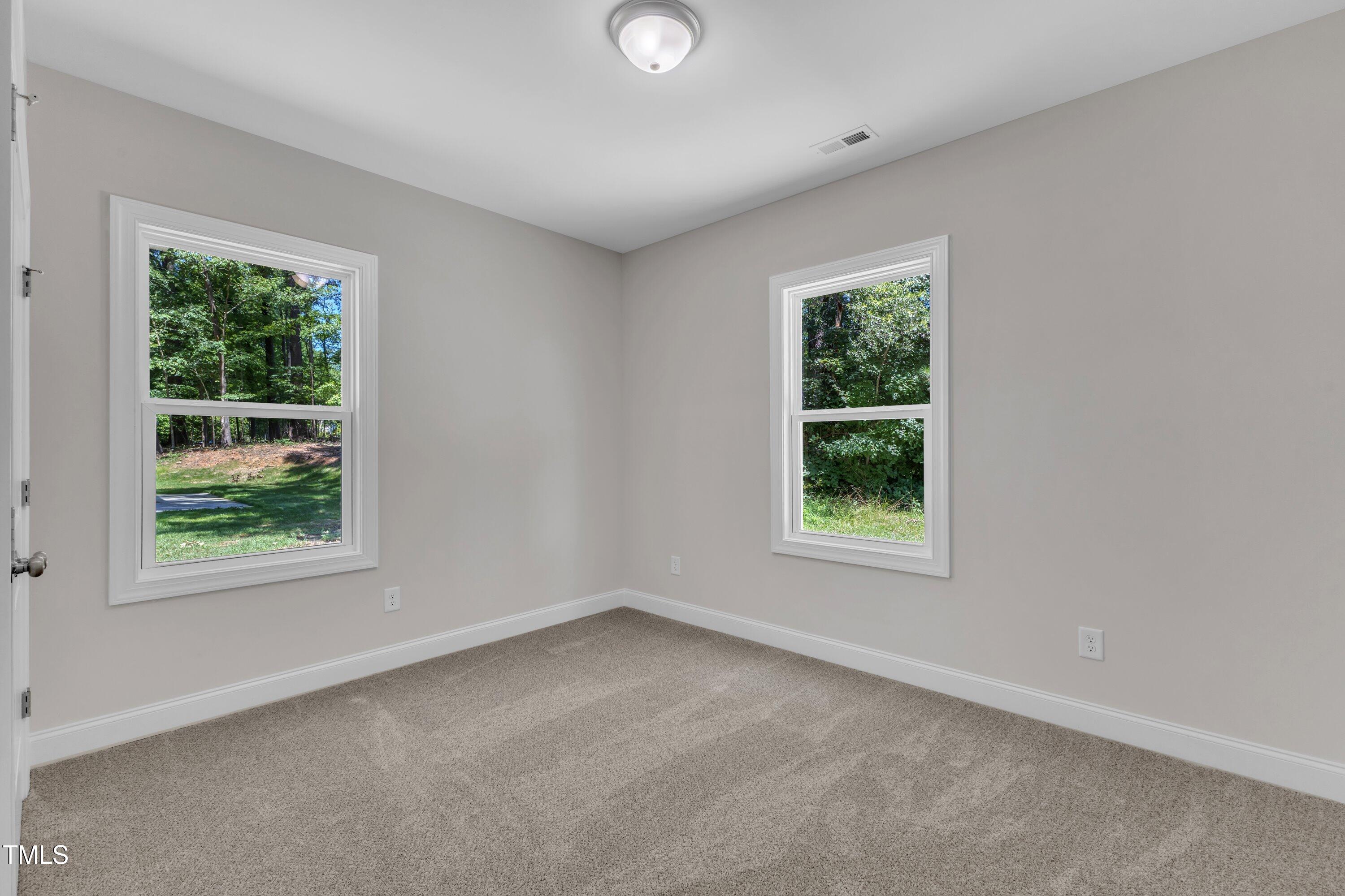 125 Davis Street Louisburg, NC 27549 - Photo 32 of 39 an empty room with windows