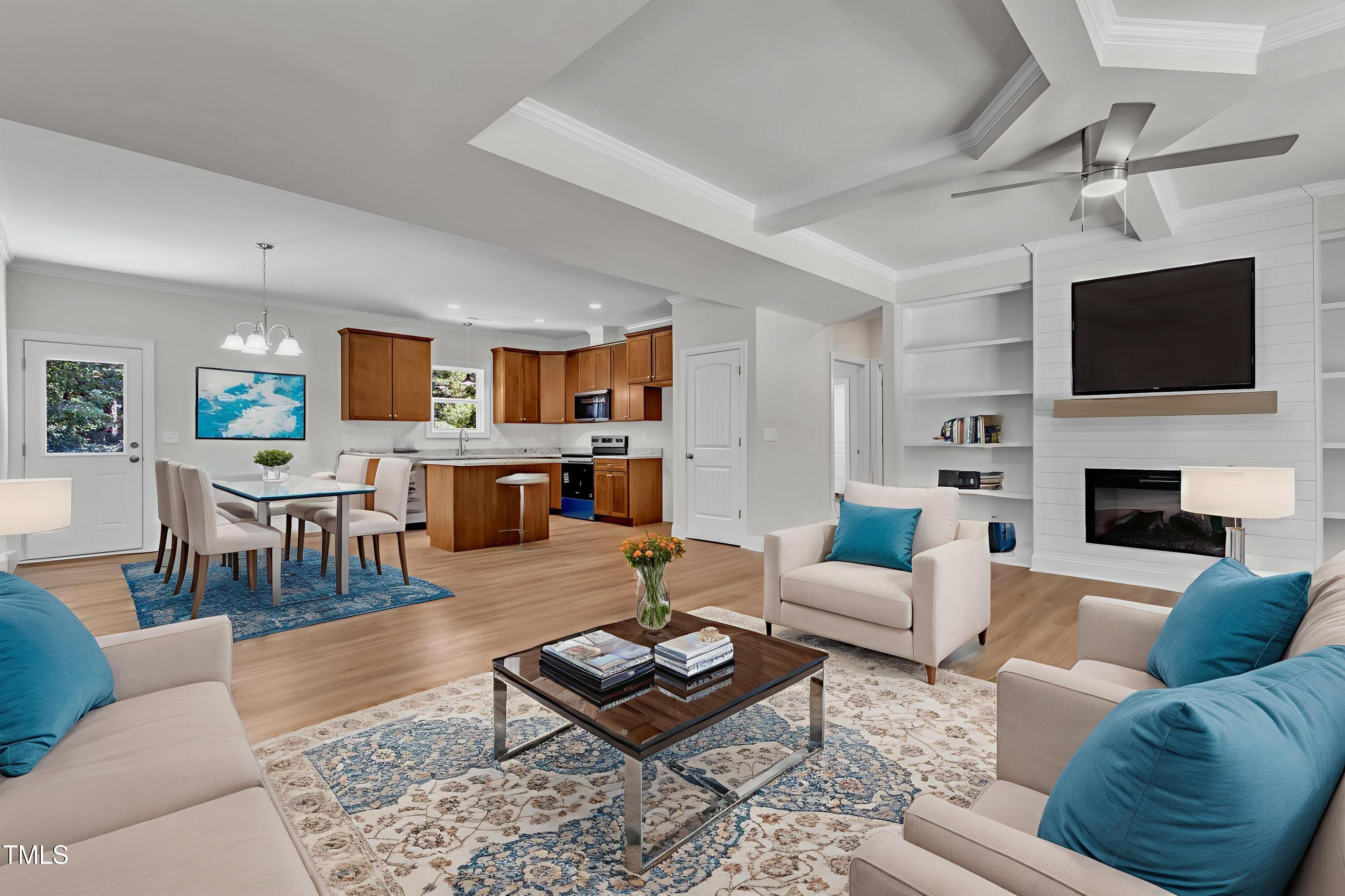 125 Davis Street Louisburg, NC 27549 - Photo 3 of 39 a living room with furniture a flat screen tv and a fireplace
