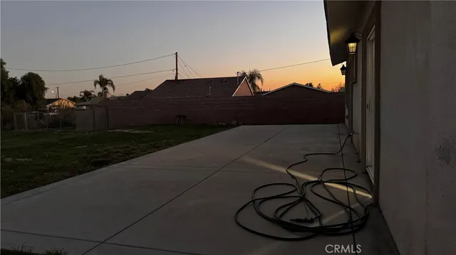 a view of a hallway with wooden floor and a bathroom