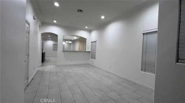 an empty room with a mirror and a sink