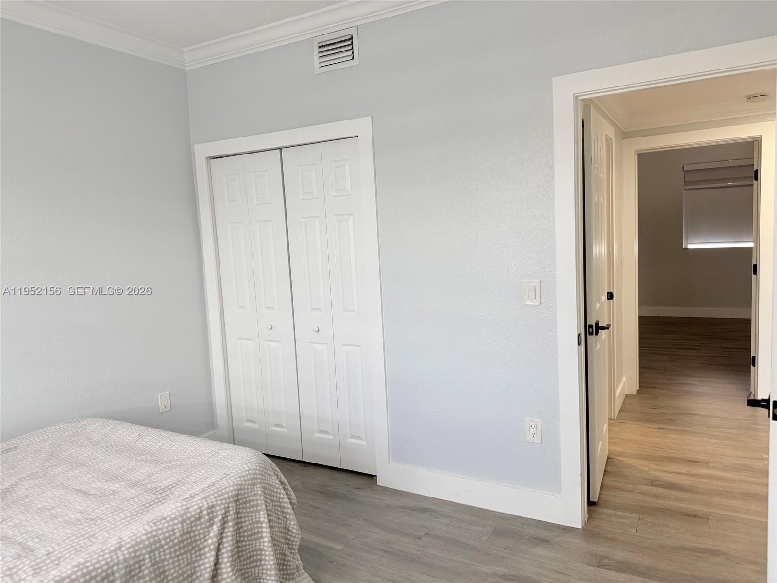 7330 Northwest 174th Terrace, Unit 204 Hialeah, FL 33015 - Photo 11 of 18 a view of a bedroom with wooden floor