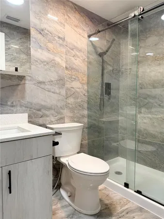 a bathroom with a toilet and a shower