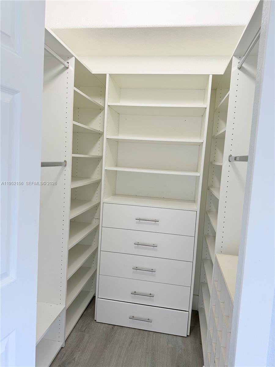 7330 Northwest 174th Terrace, Unit 204 Hialeah, FL 33015 - Photo 15 of 18 a view of walk in closet with empty racks